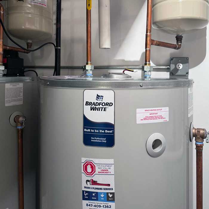 Plumber installing a modern conventional water heater